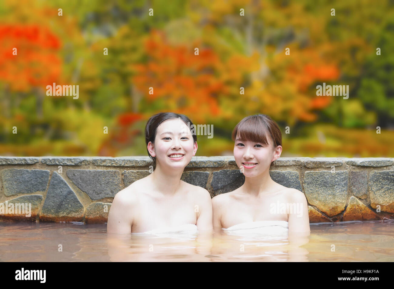 Young Japanese women bathing at traditional onsen hot spring Stock
