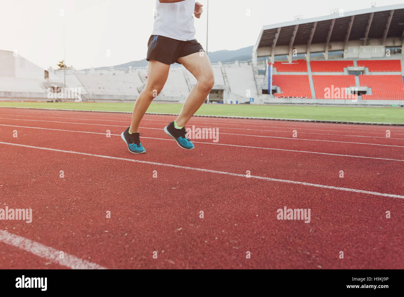Runners sprinting outdoors Sportive people training in a urban area, healthy lifestyle and sport concepts. Stock Photo
