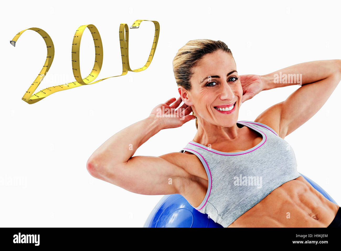 3D Composite image of fit woman doing sit ups on blue exercise ball smiling at camera Stock Photo
