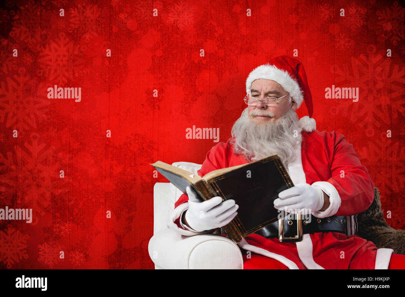 Composite image of santa claus reading bible Stock Photo Alamy