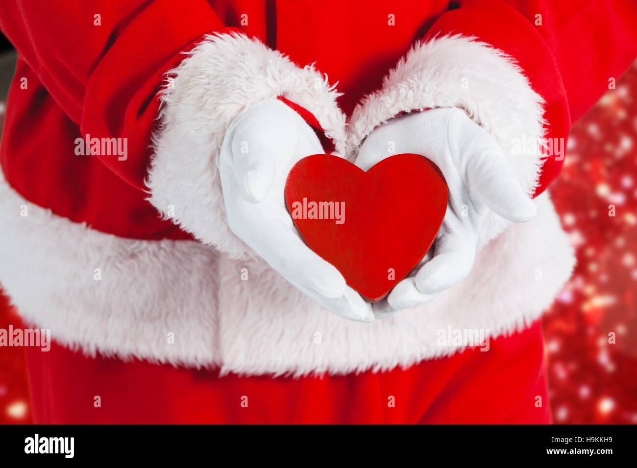 Composite image of santa claus showing red heart shape Stock Photo