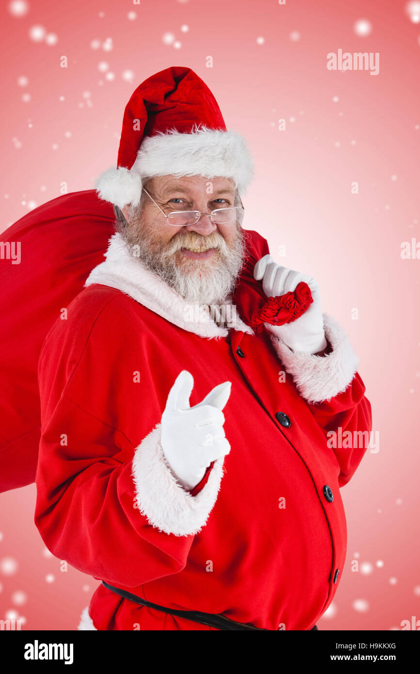 Composite image of portrait of santa claus pointing while carrying ...
