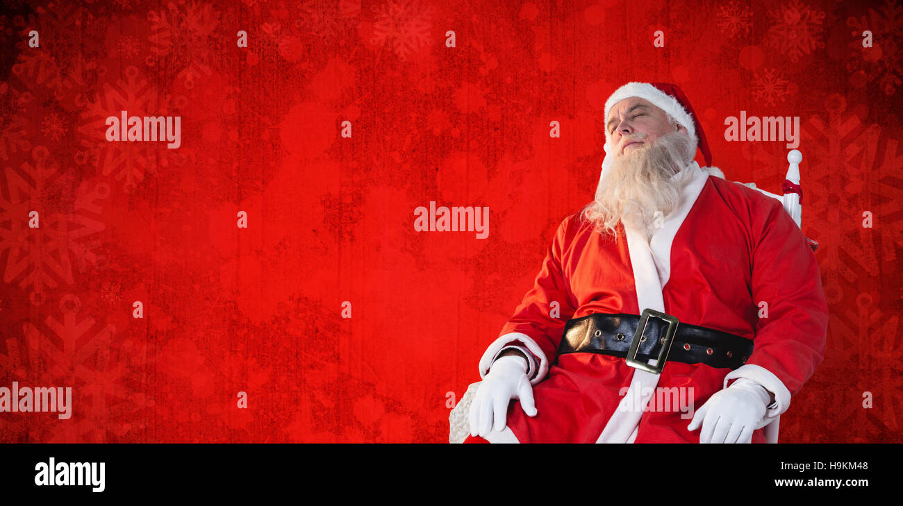 Composite image of santa claus relaxing on chair Stock Photo