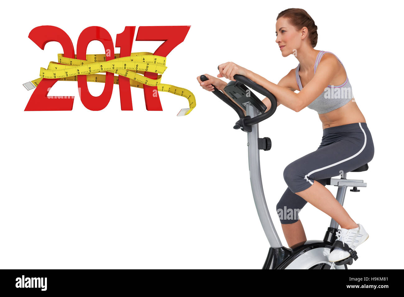 3D Composite image of side view of a beautiful woman on stationary bike Stock Photo