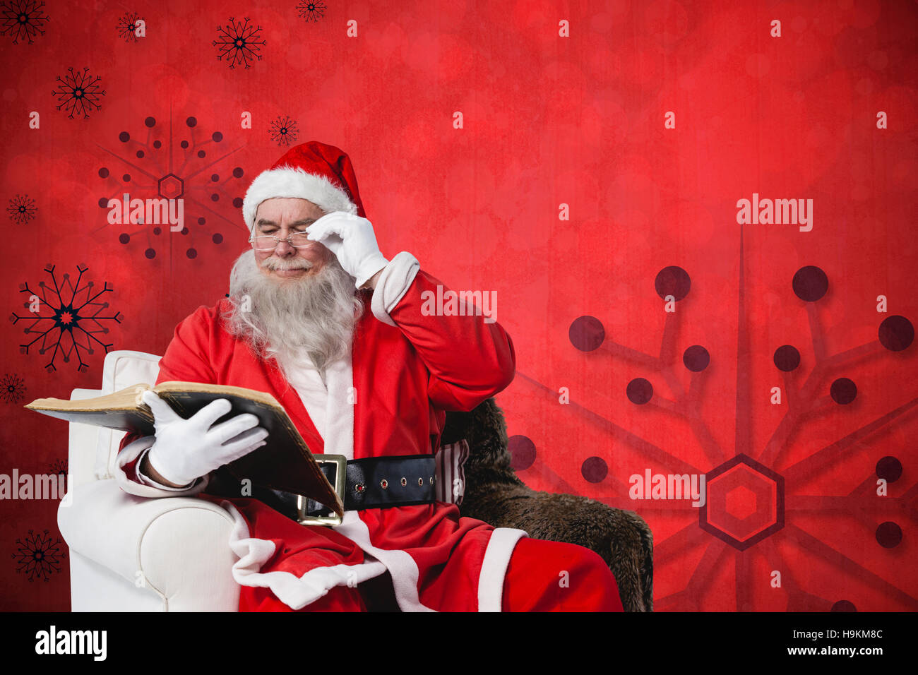 Composite image of santa claus reading bible on armchair Stock Photo ...