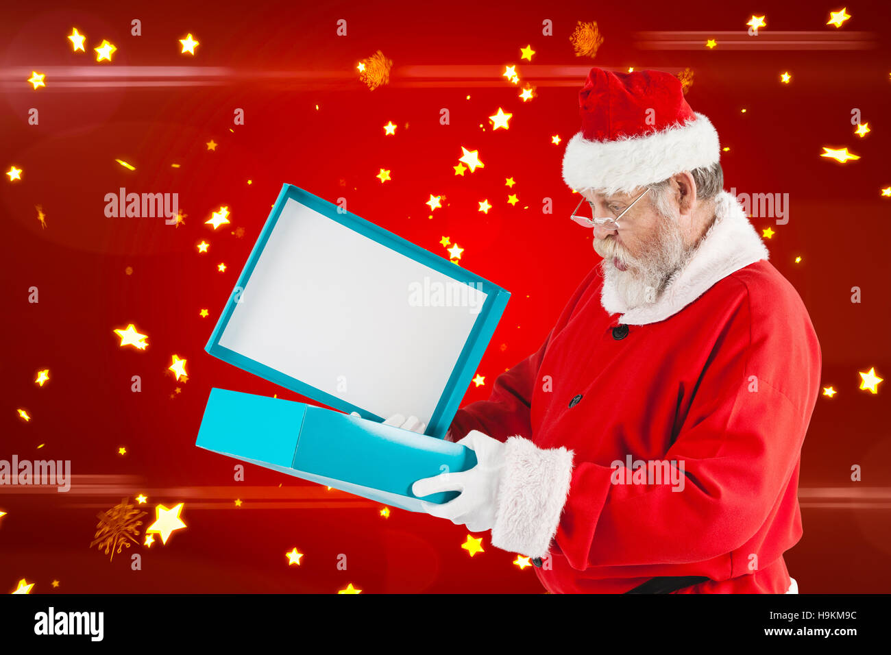 Composite image of santa claus opening gift box Stock Photo