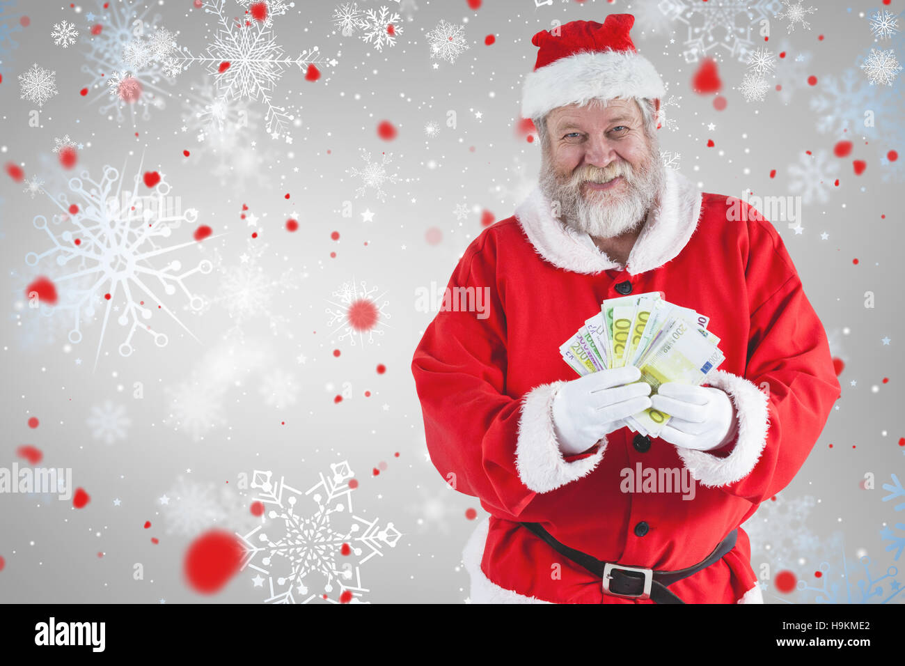 Composite image of santa claus showing currency notes Stock Photo