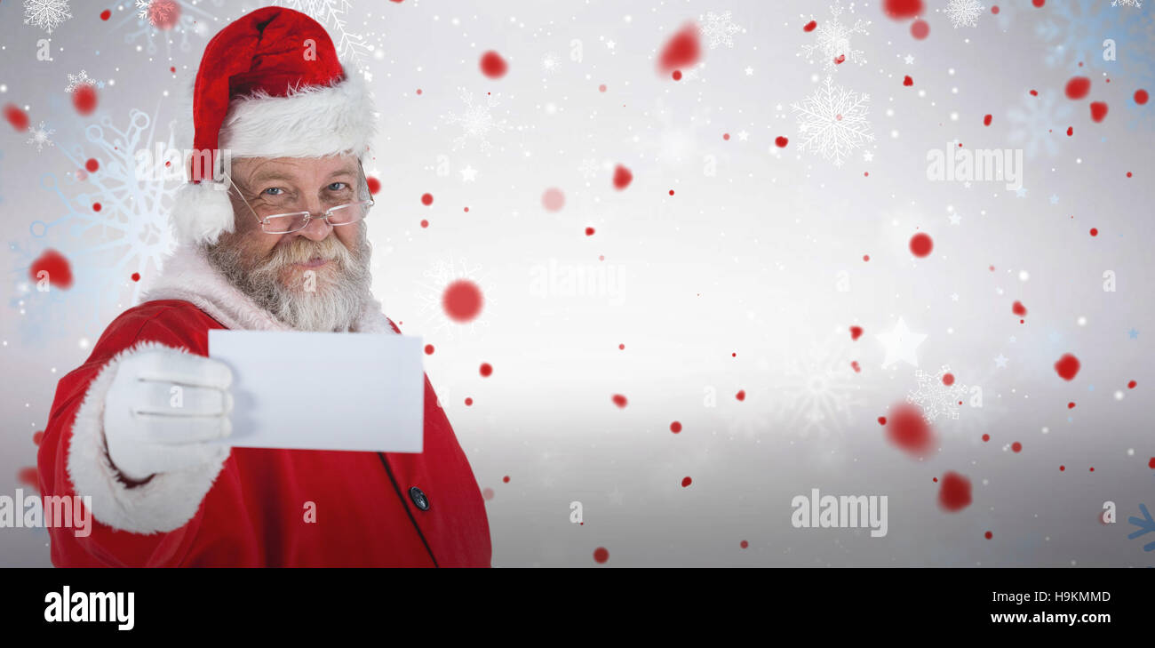Composite image of close-up of santa claus holding blank paper Stock Photo