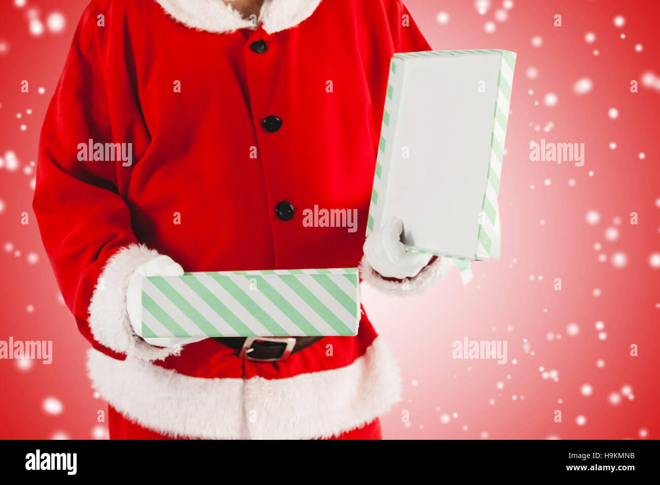 Composite image of midsection of santa claus opening gift box Stock Photo