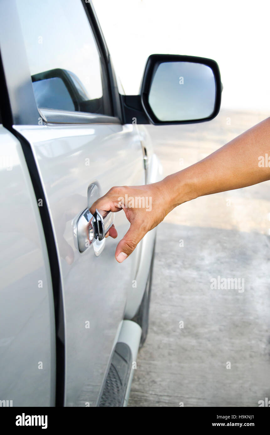 Hand opening a car door Stock Photo