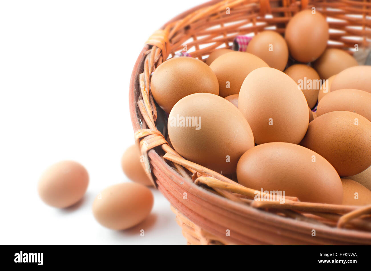 Chicken brown eggs in wicker basket Stock Photo
