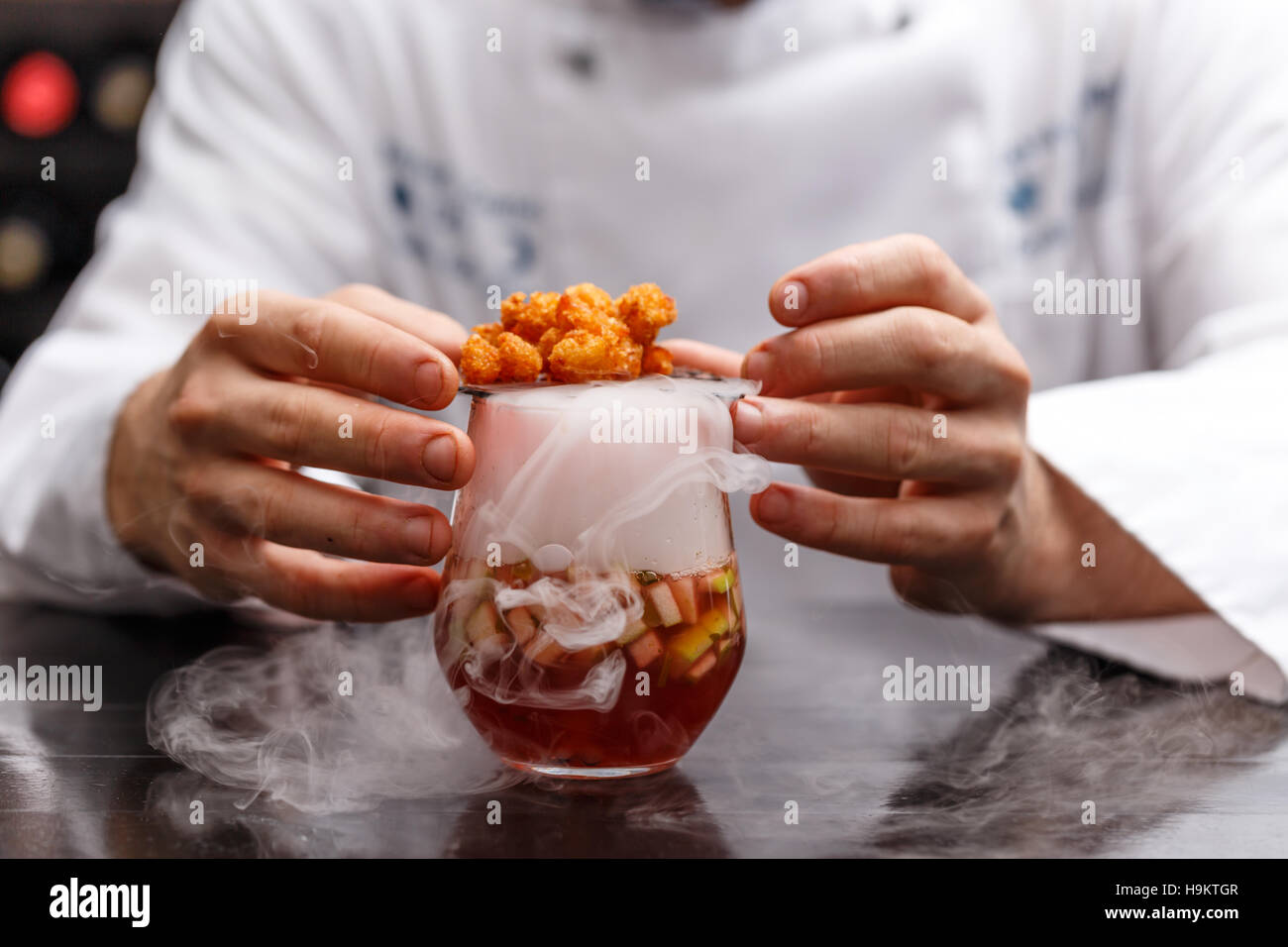 Fruit soup with dry ice, Chef decorating Stock Photo