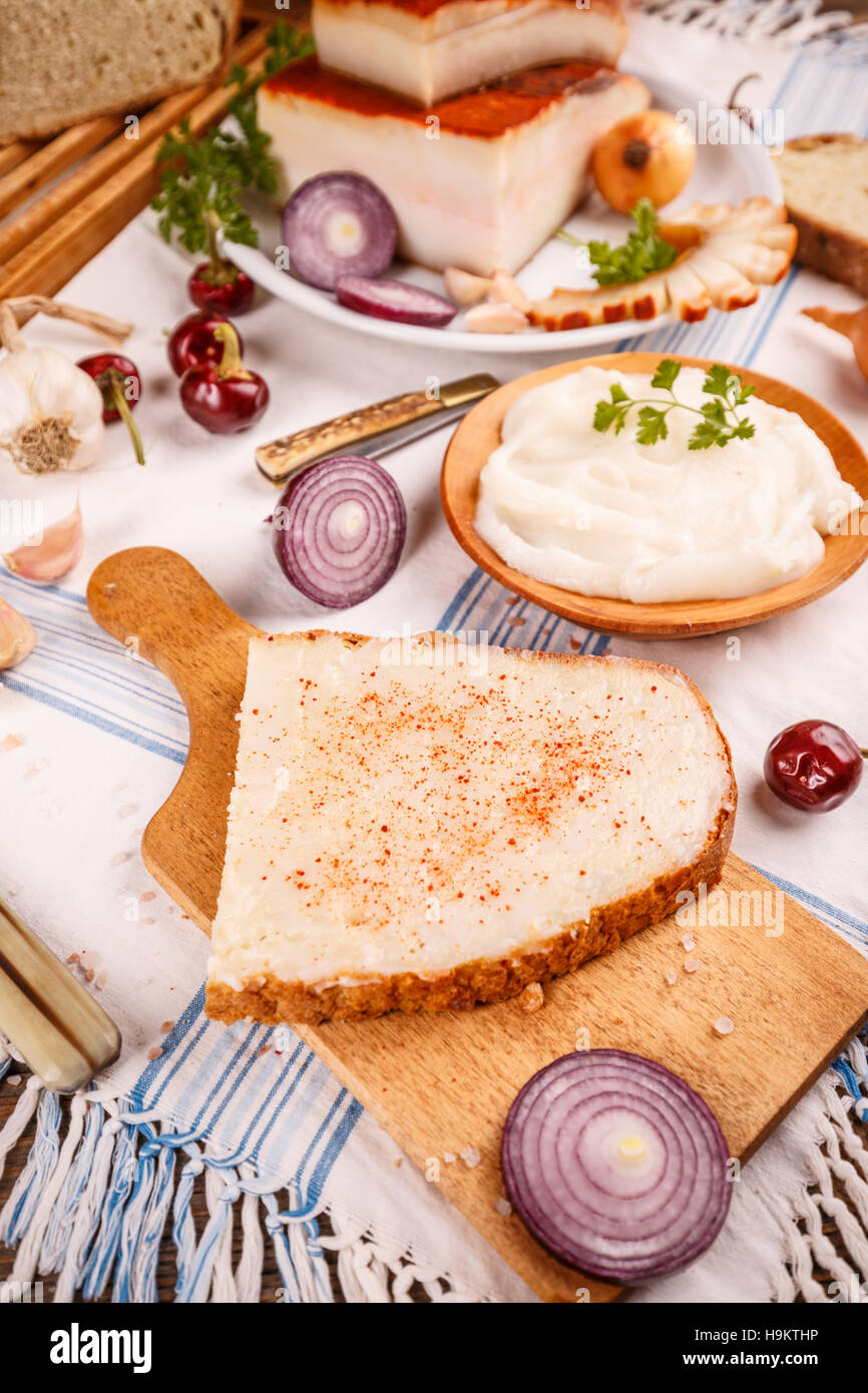 Lard spread on home baked bread, rustic table Stock Photo - Alamy