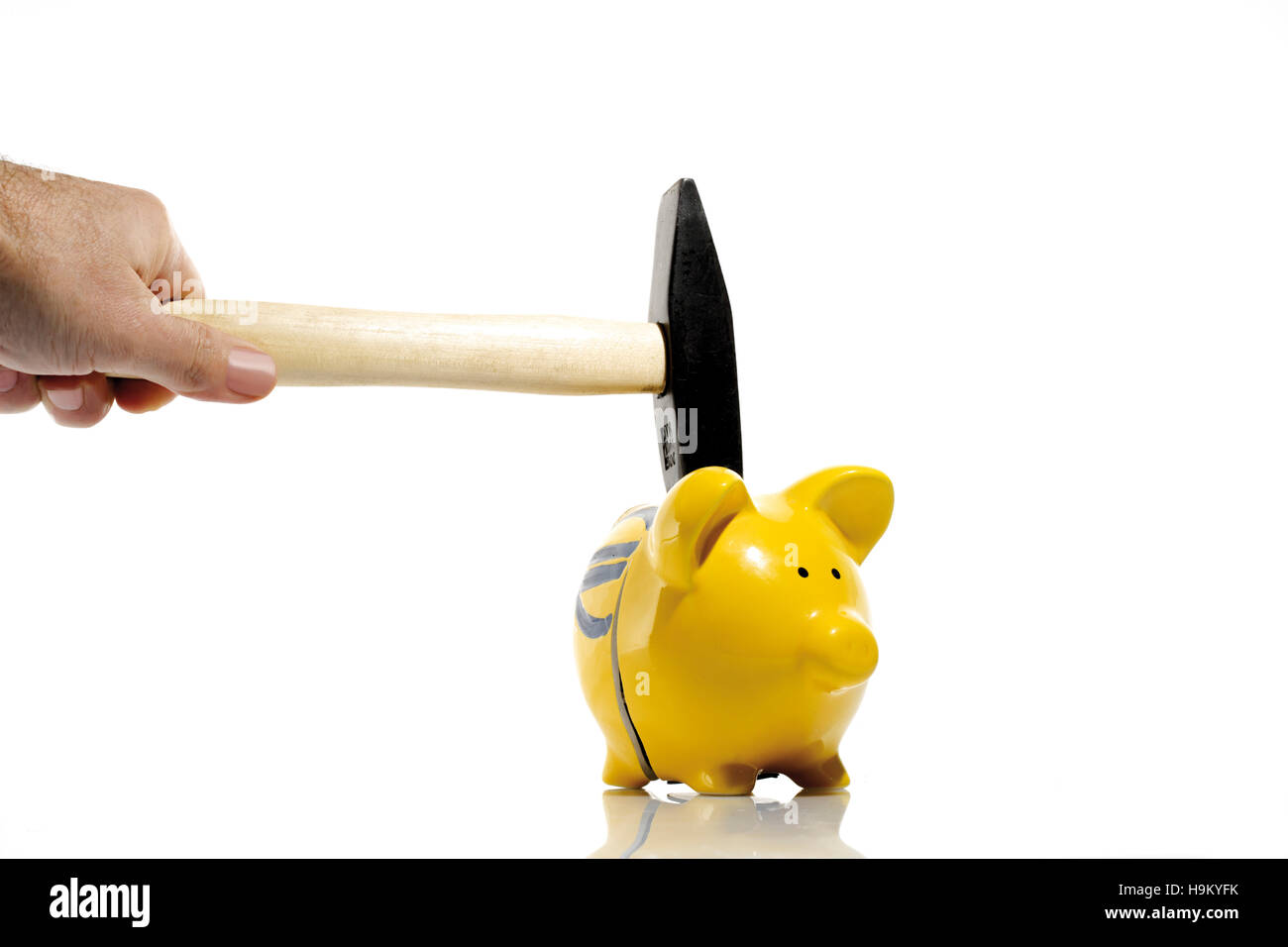 Hammer and a yellow piggy bank Stock Photo - Alamy
