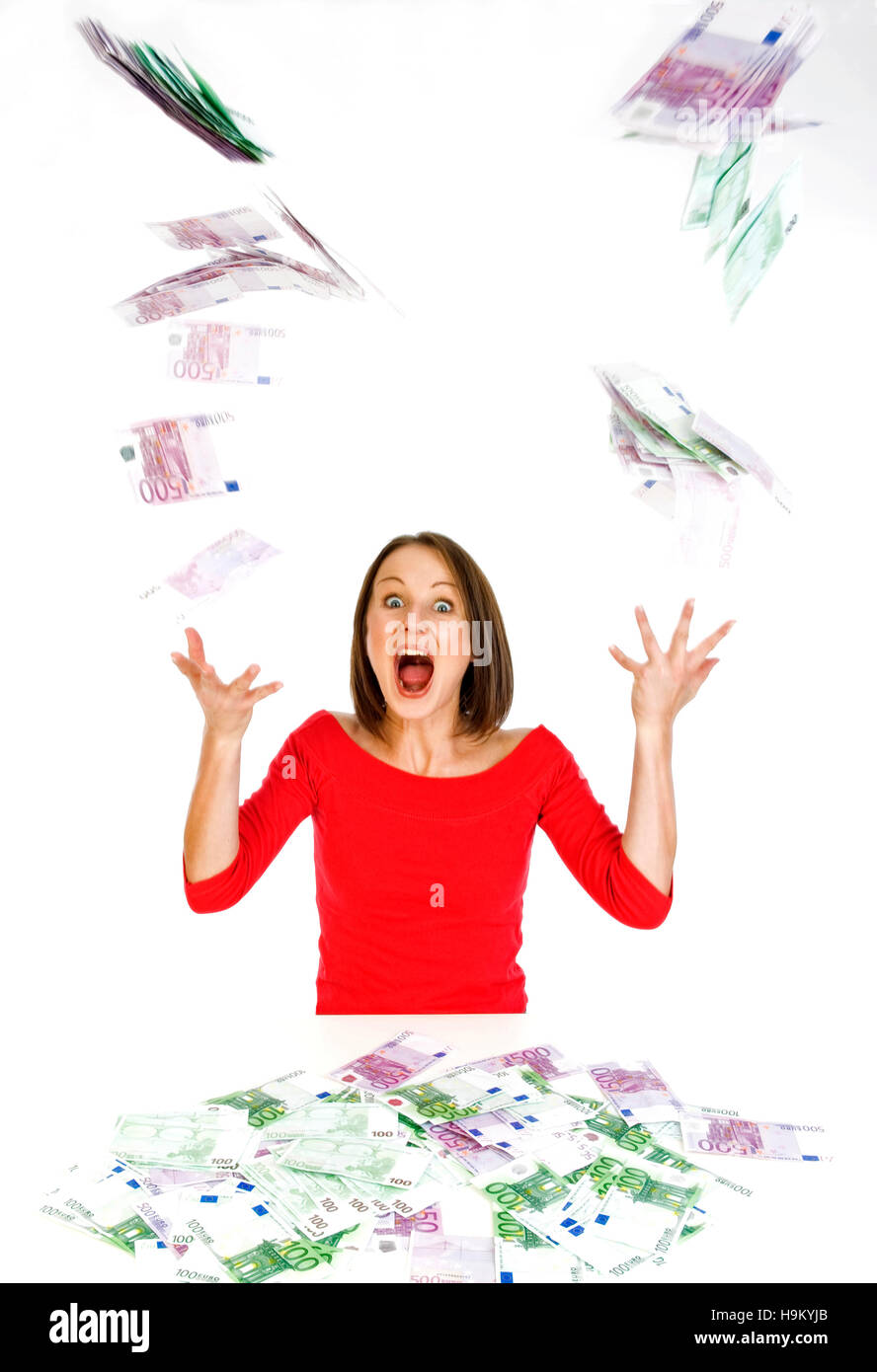 Young woman throwing money Stock Photo