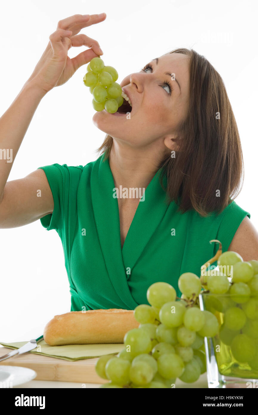 Young woman eating grapes Stock Photo Alamy