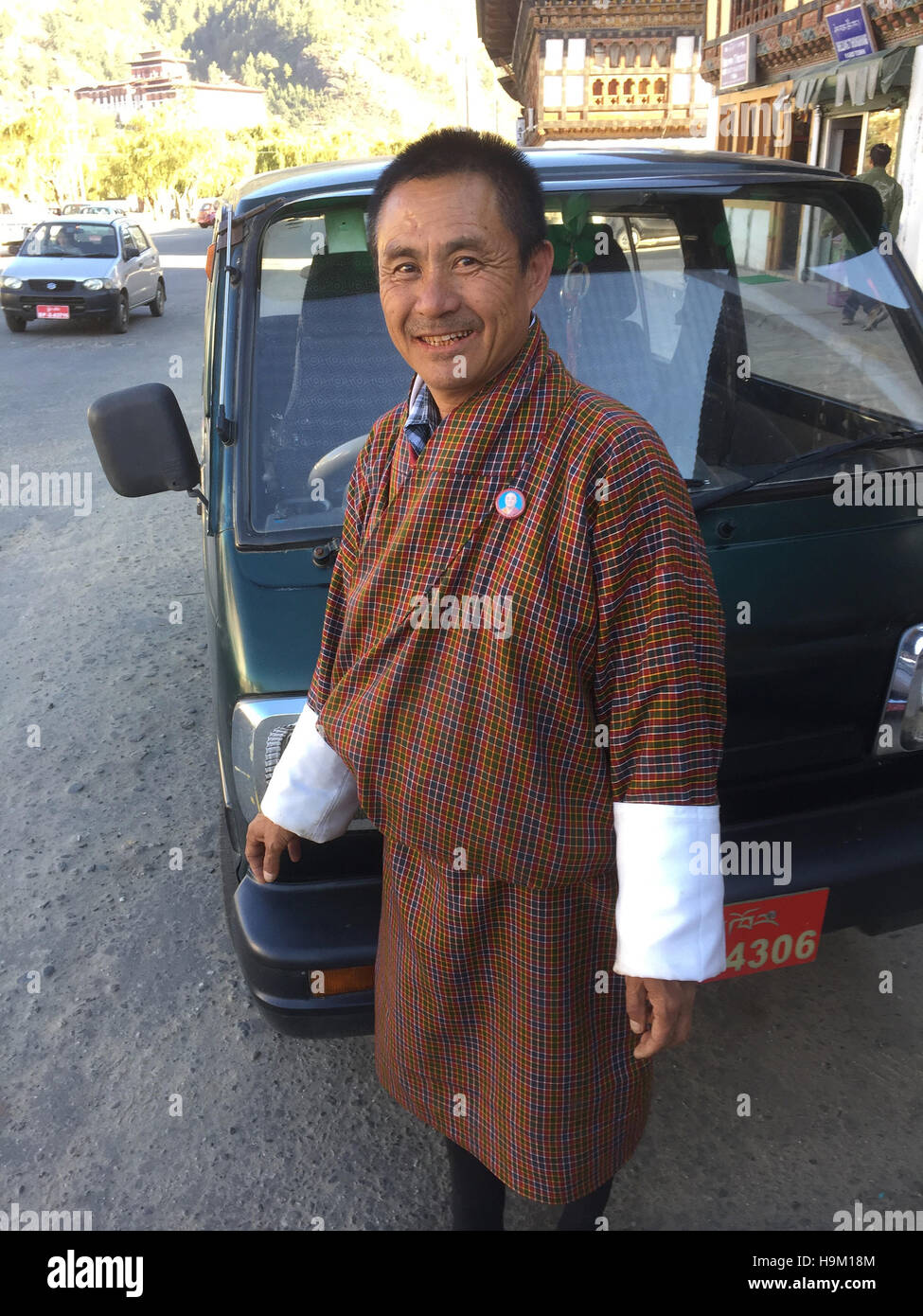 BHUTAN  Taxi driver wearing national dress in the capital Thimpu. Photo Tony Gale Stock Photo