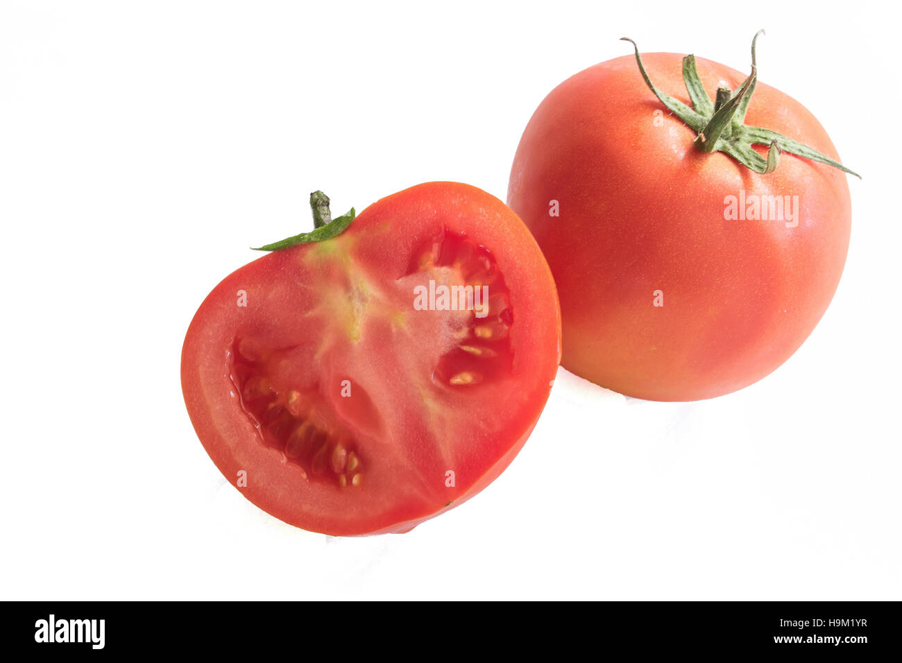 Fresh red tomato with green stem on white background, with clipping path Stock Photo