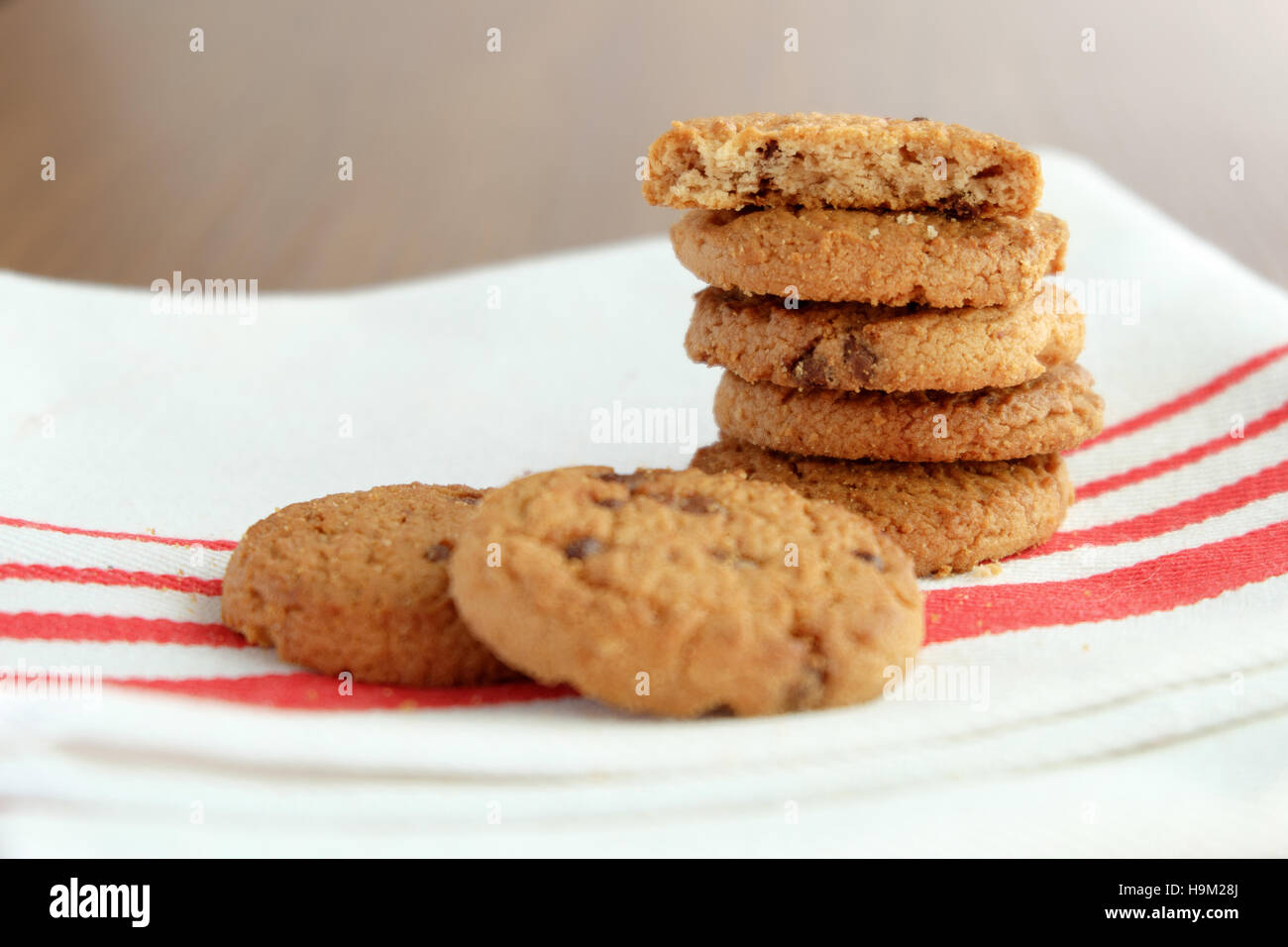 Chocolate chip cookies on white linen napkin on wooden tab, selective focus Stock Photo