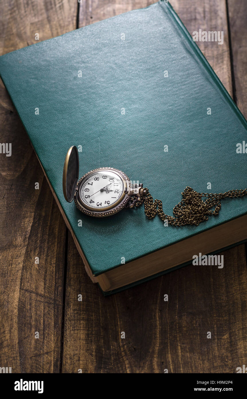 Vintage pocket watch lie on a  old book Stock Photo