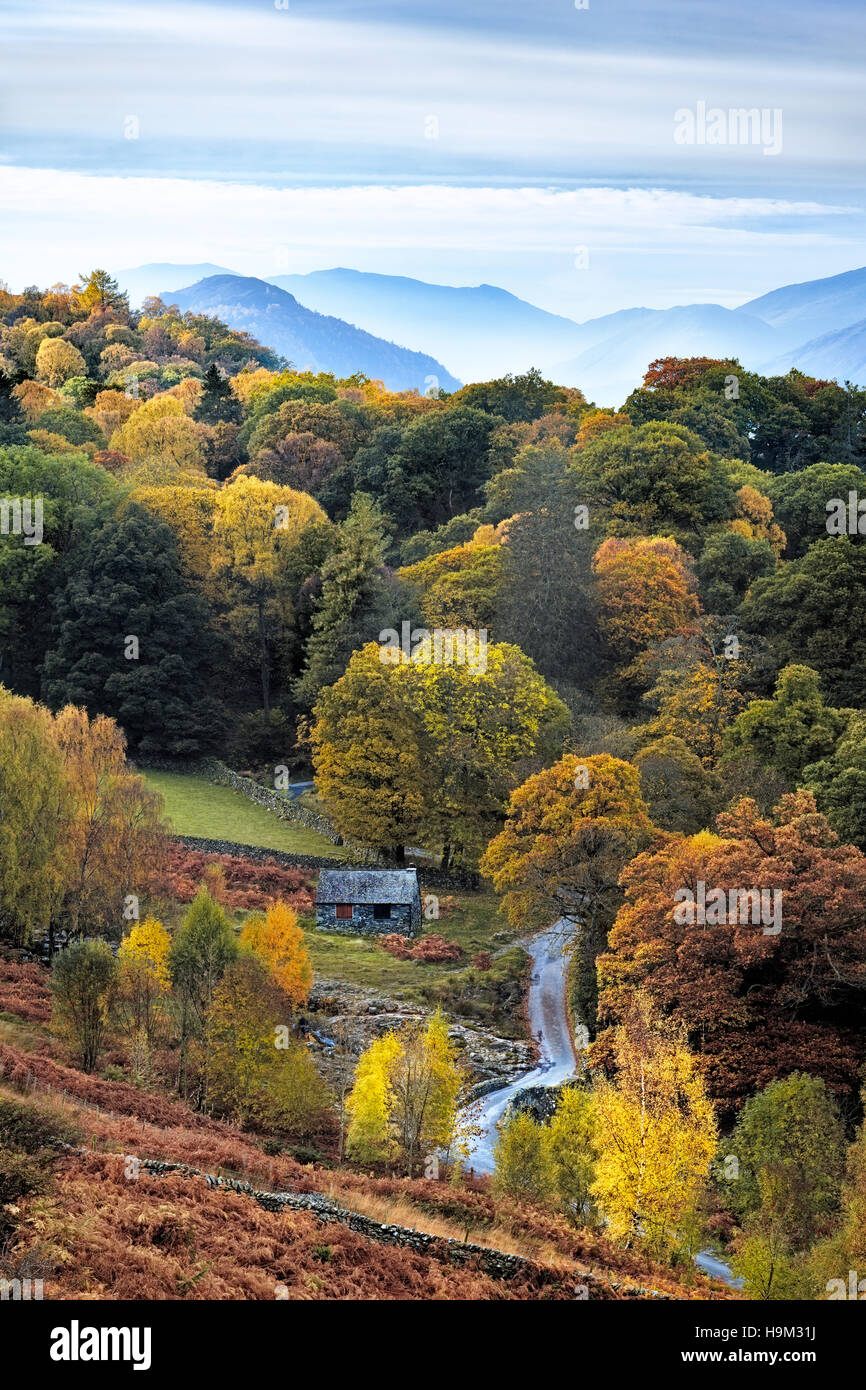 An ancient brigde called Ashness bridge on the hills surrounding Derwent Water can be seen in this Autumnal Lake District image. Stock Photo