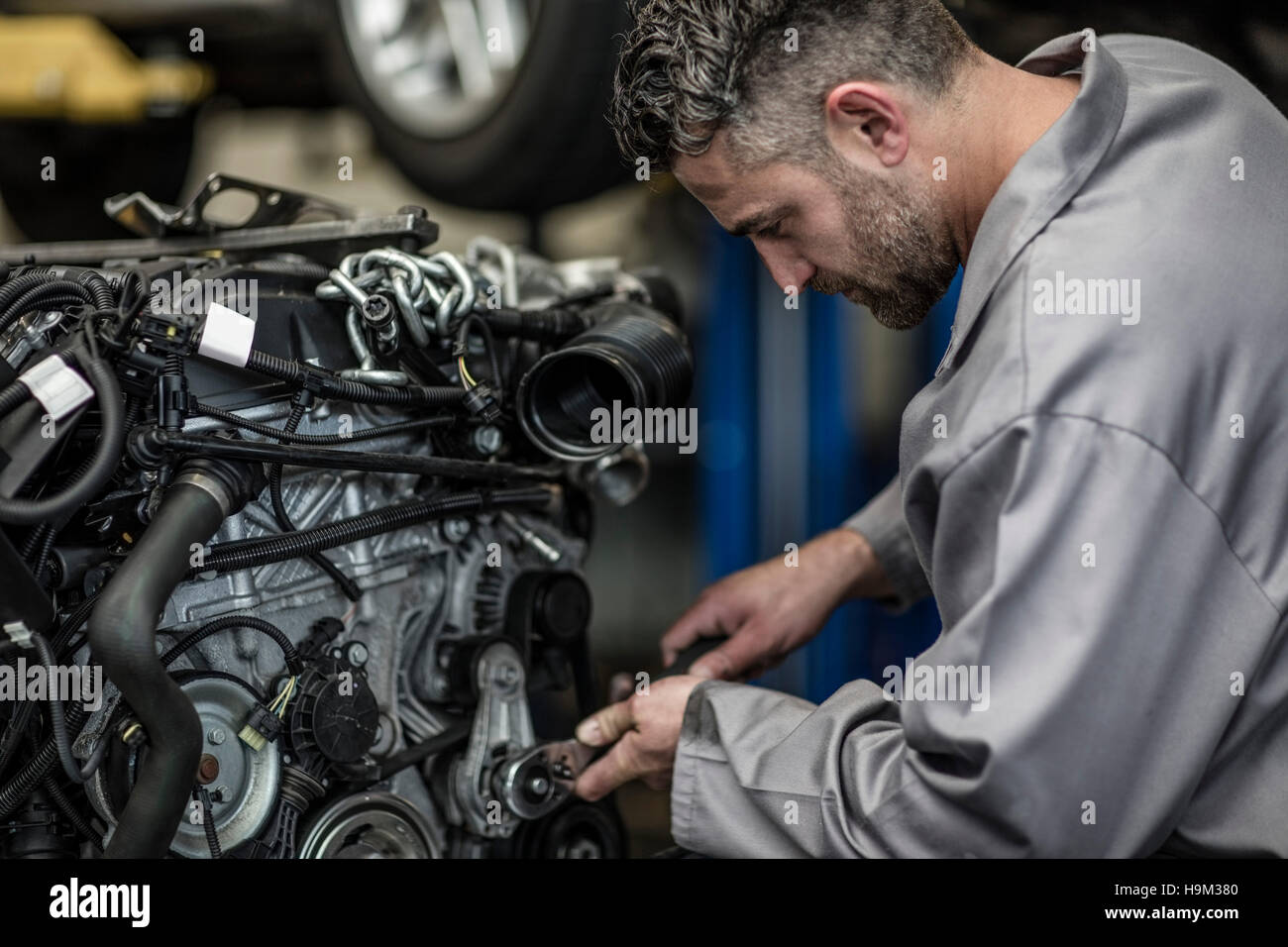 Car mechanic in a repairing engine Stock Photo Alamy