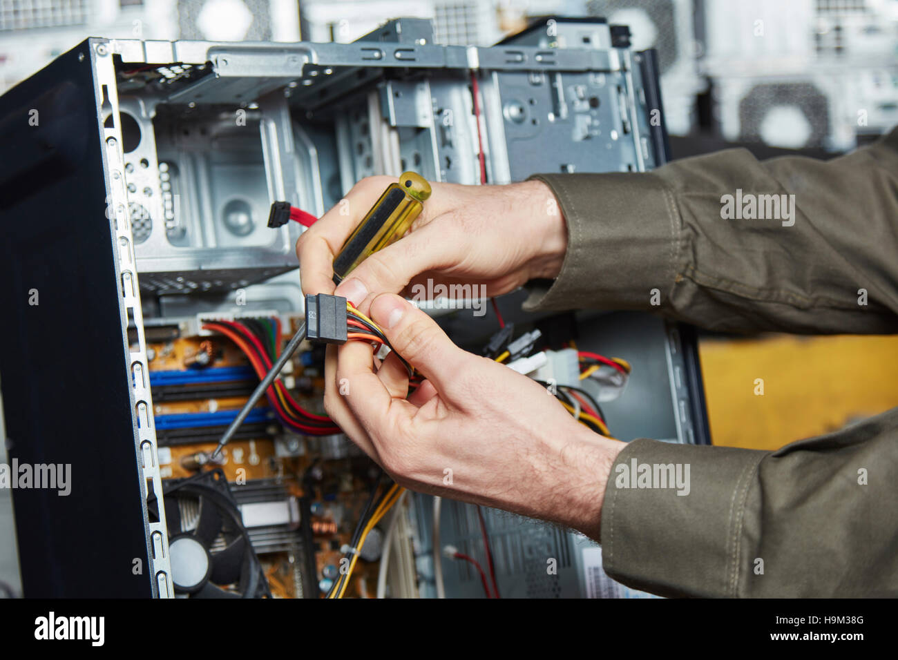 Worker in computer recycling plant dismantling desktop pc Stock Photo ...