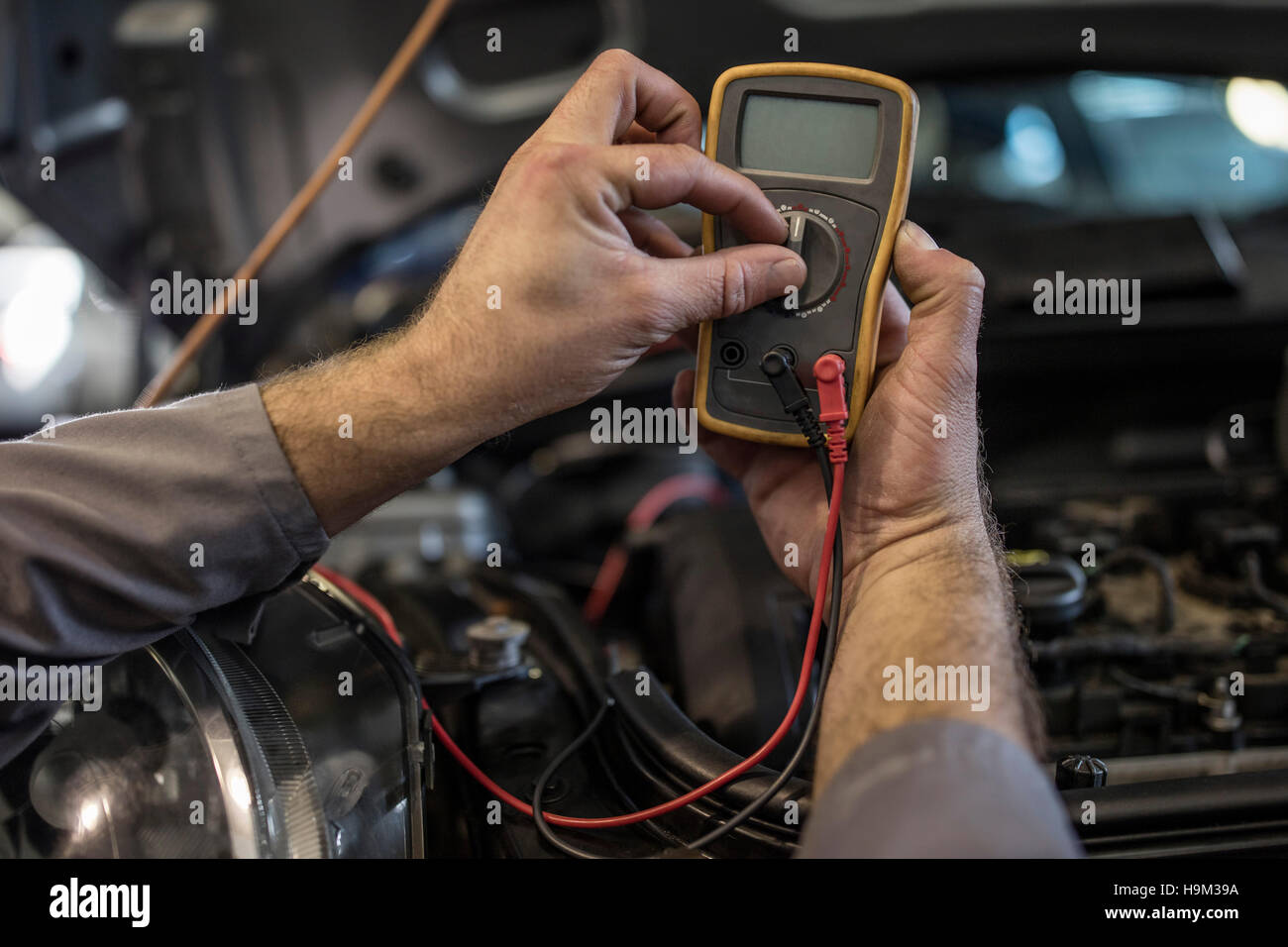 Closeup of car mechanic in a using diagnostic equipment Stock