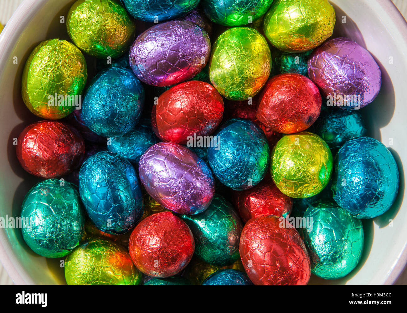 Conceptual close up photo of chocolate easter eggs wrapped in coloured foil Stock Photo