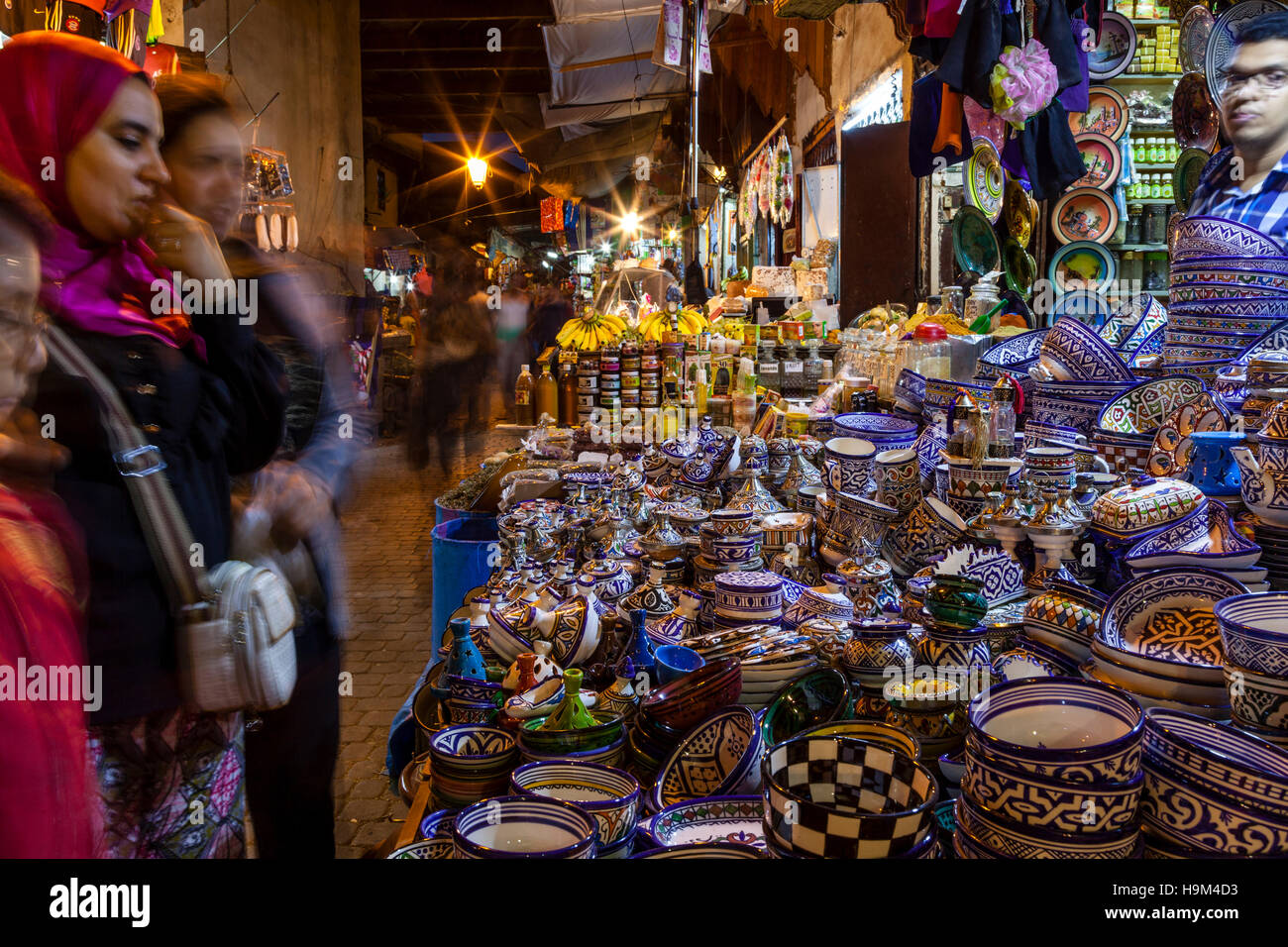 Moroccan Women Shopping In The Medina At Night, Fez el Bali, Fez, Morocco Stock Photo