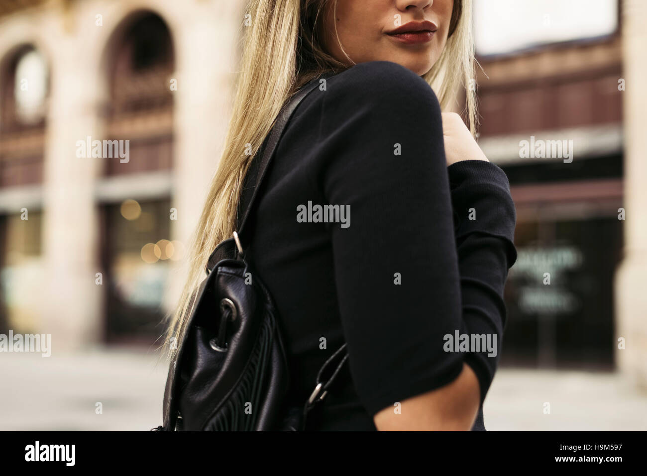 Young woman carrying shoulder bag in the city Stock Photo Alamy