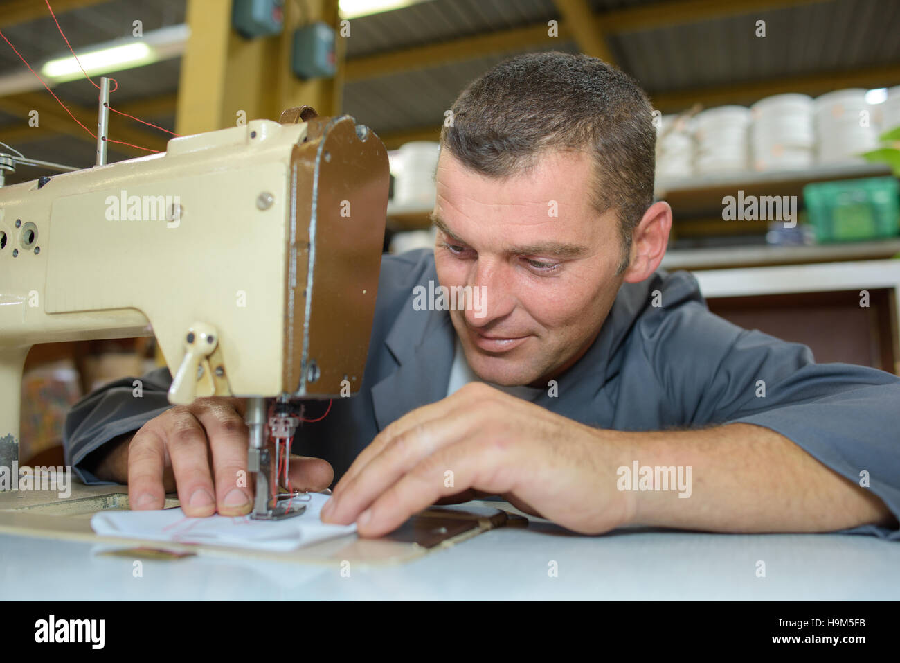 man on sewing machine Stock Photo Alamy