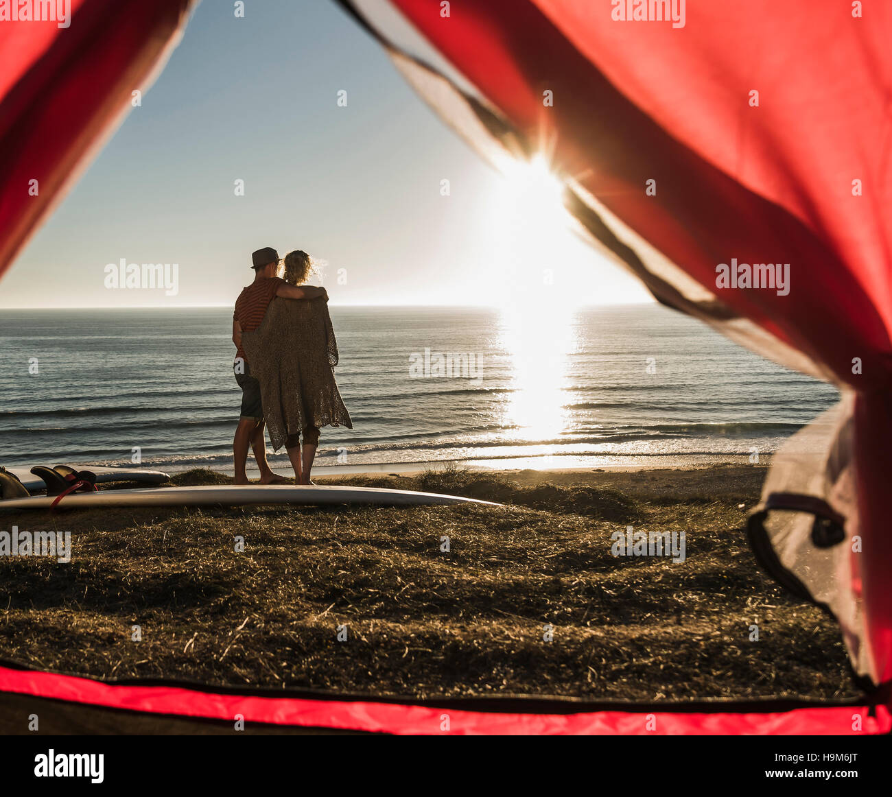 Young couple in love camping at seaside Stock Photo