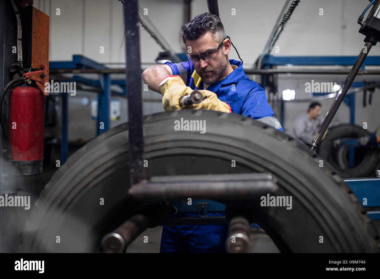 Tire repairman carving tire with tread cutting machine Stock Photo Alamy