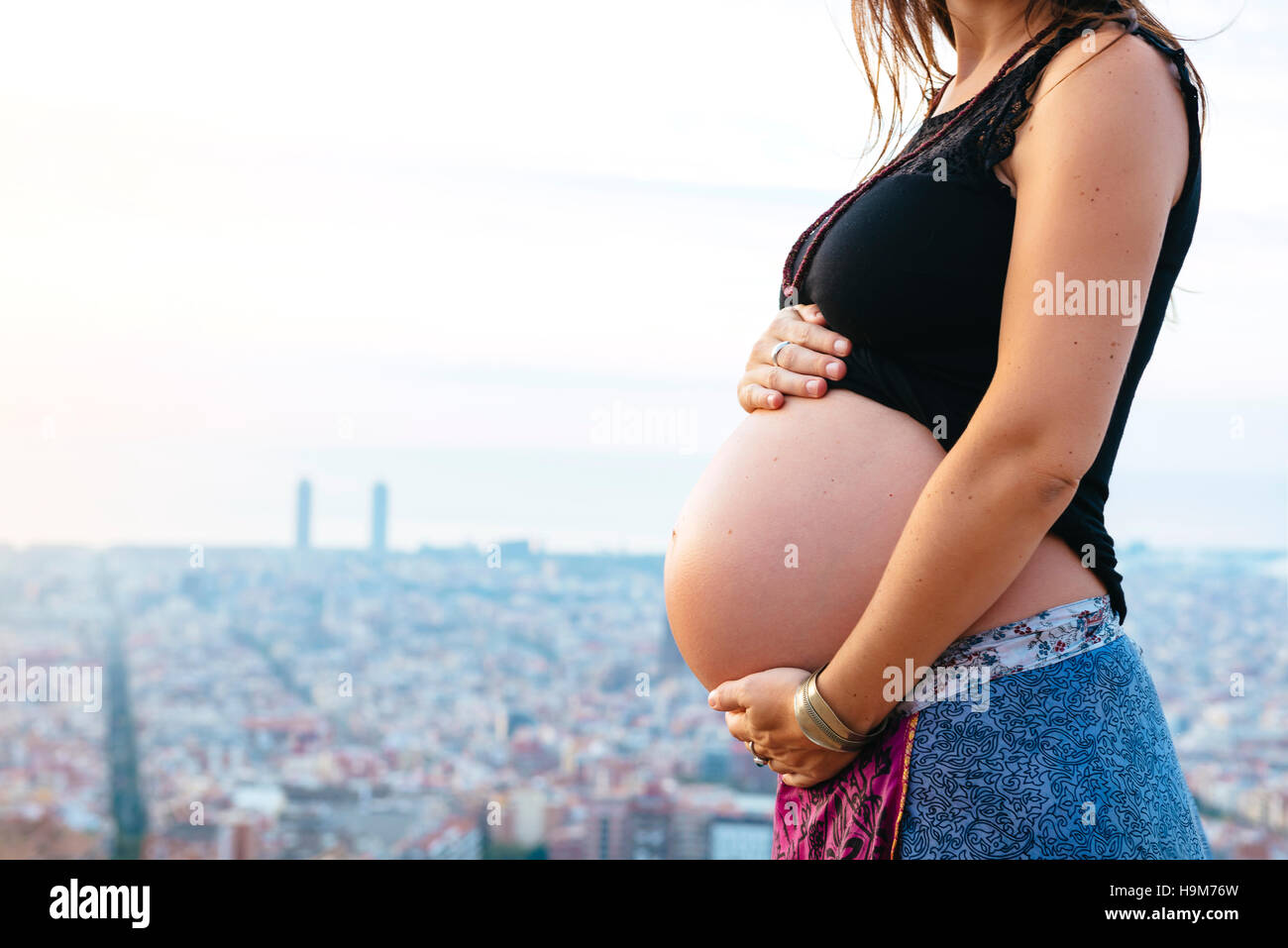 Spain, Barcelona, Pregnant woman enjoying view over city Stock Photo
