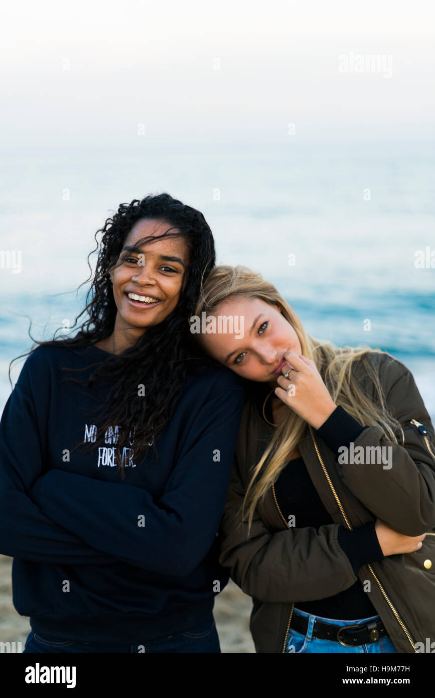 Portrait of two happy young women on the beach Stock Photo - Alamy