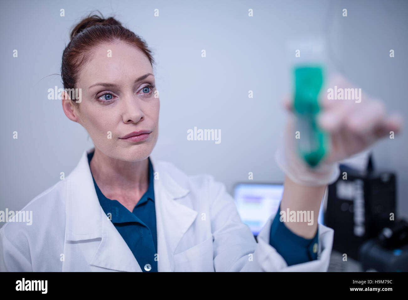 Woman holding test tube in laboratory Stock Photo - Alamy