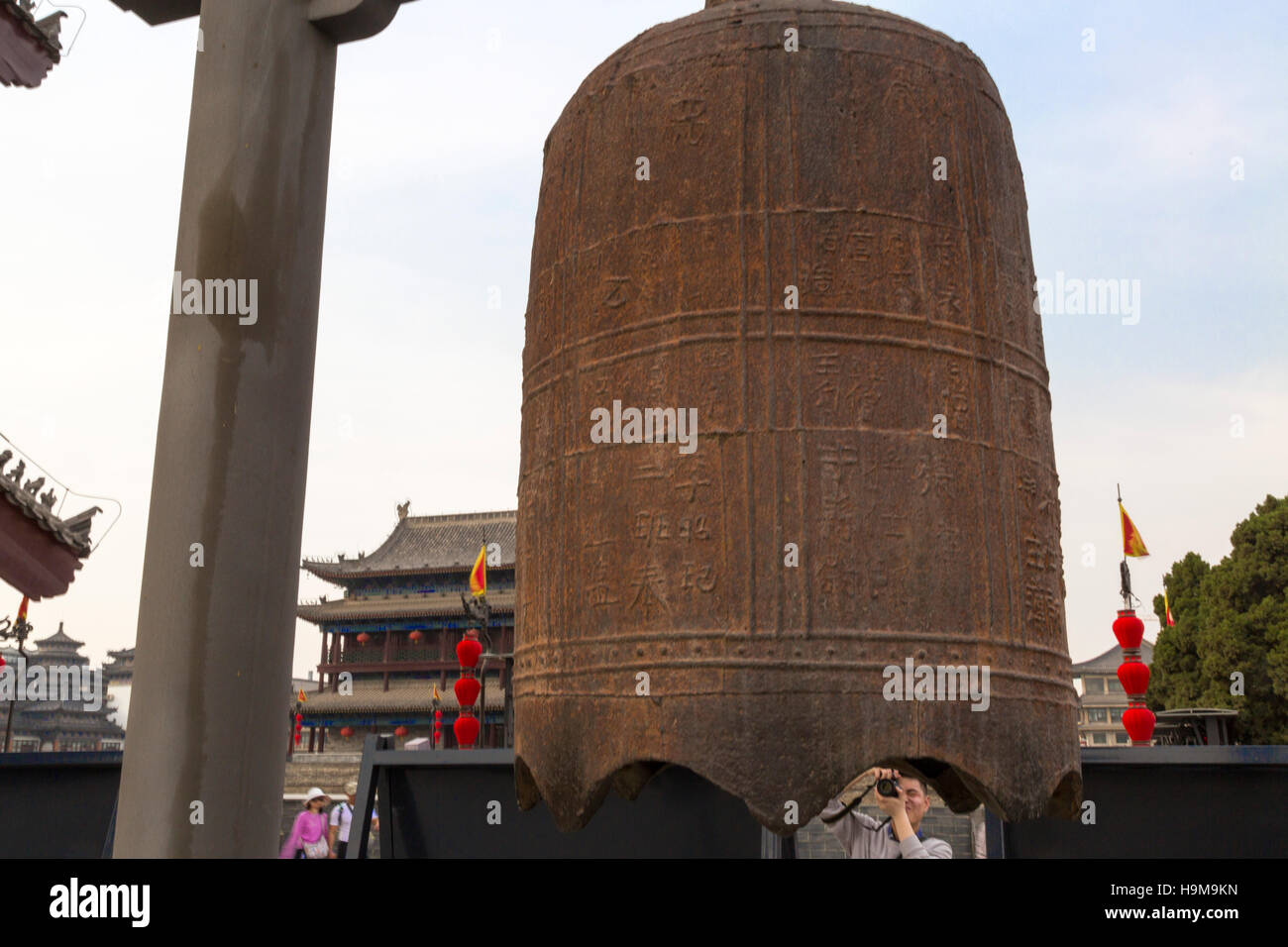 Tourist taking photo of bell onXian city walls, Shaanxi, China Stock Photo