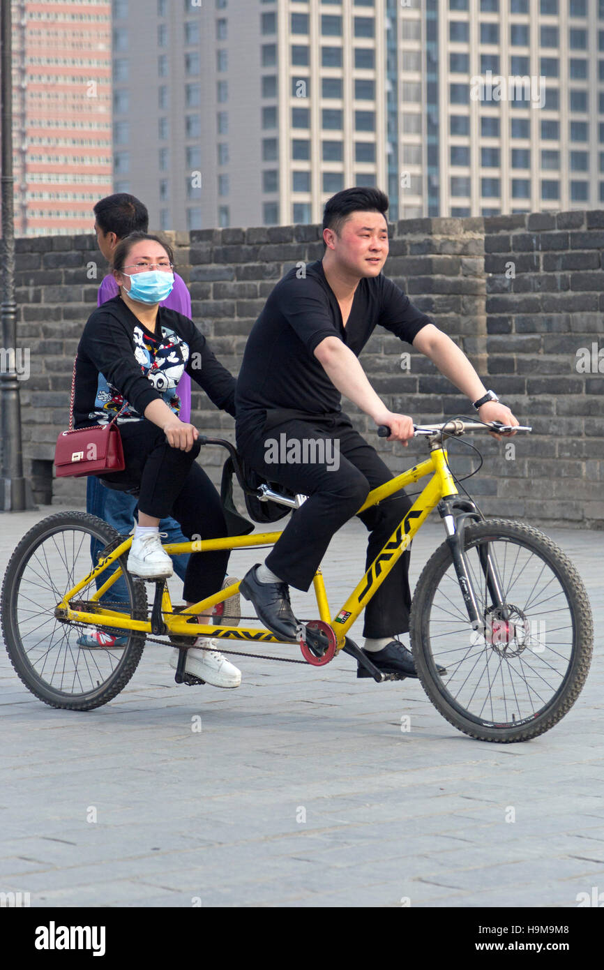Tourists riding a bicycle, Xian city walls, Shaanxi ,China Stock Photo