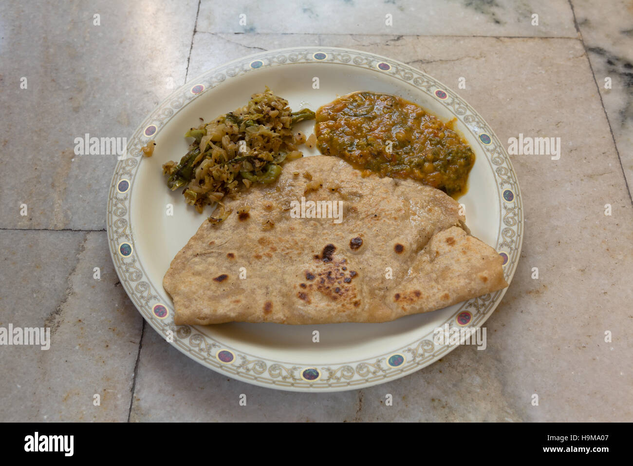 Indian breakfast meal consisting of Roti(Flat Bread),Cabbage Curry and Dal(Lentil) Stock Photo