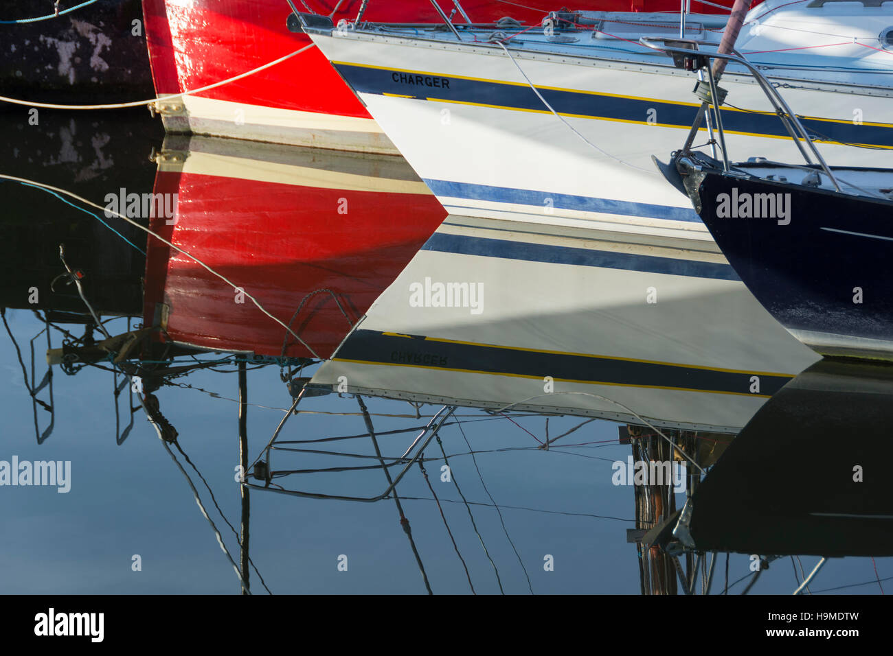 Red white and blue boats reflected in the calm waters of Bristol's