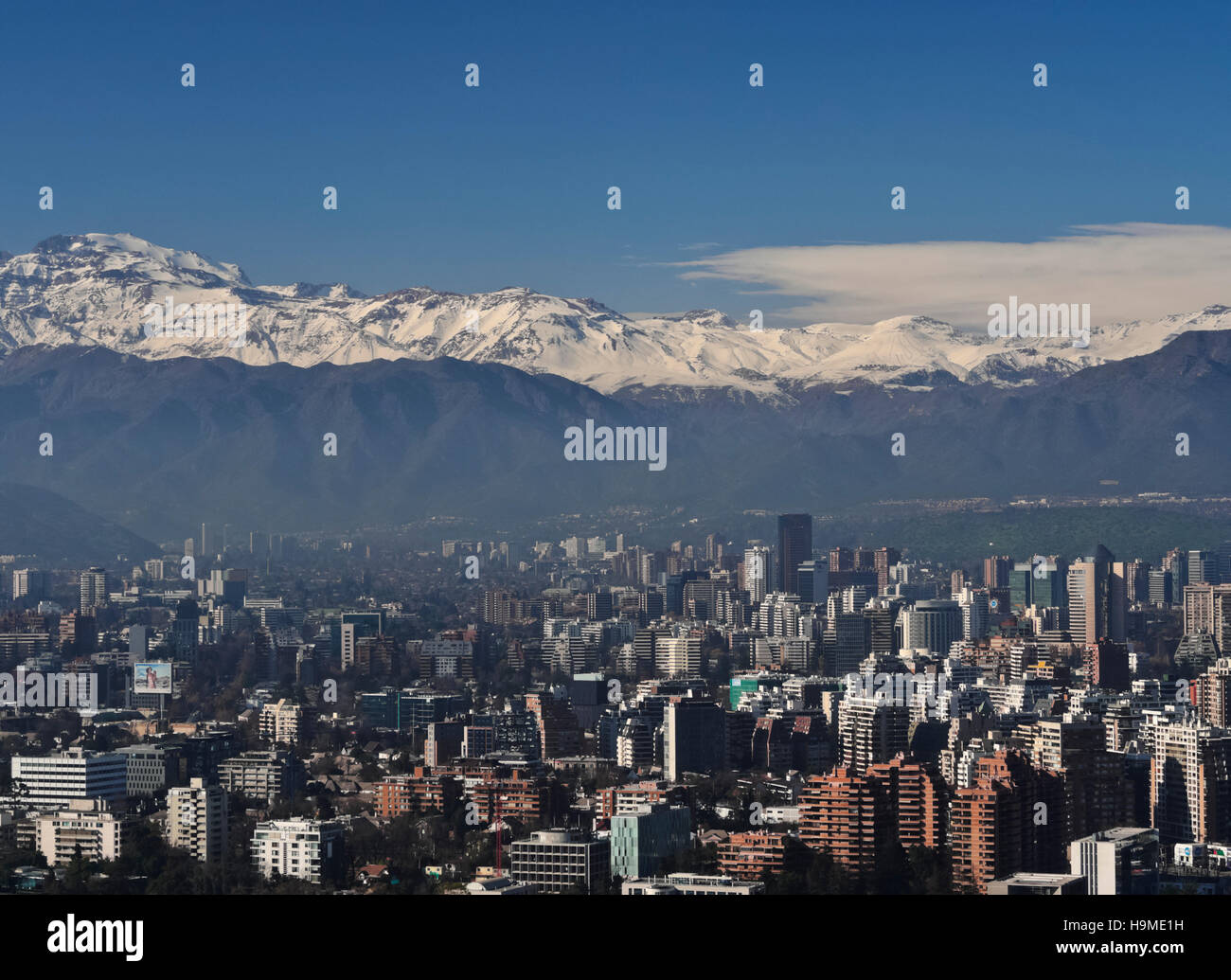 Chile Santiago View from the Parque Metropolitano towards the high raised buildings in financial sector. Snow covered Andes in Stock Photo