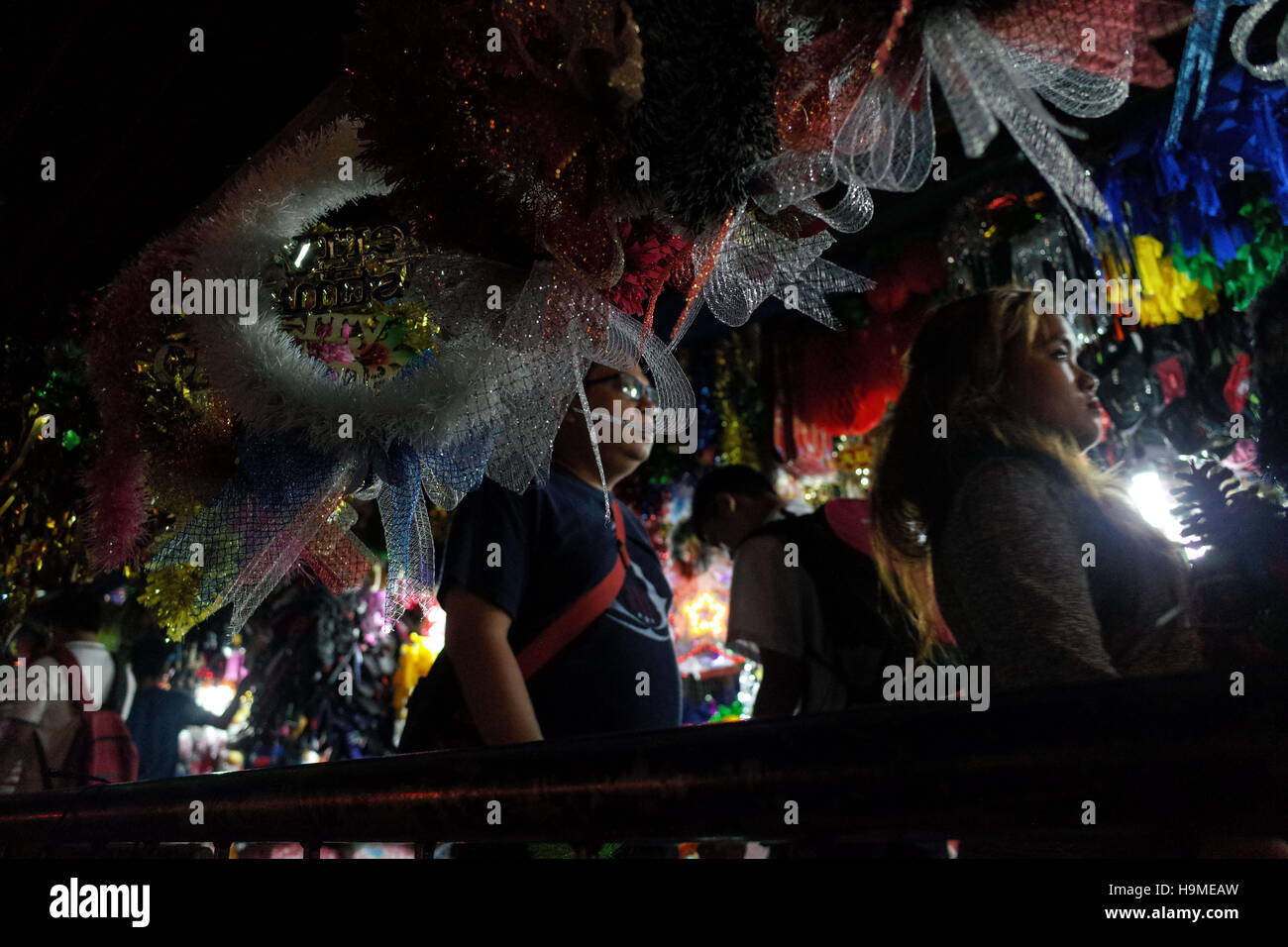 Quezon City, Philippines. 24th Nov, 2016. People walk through Christmas