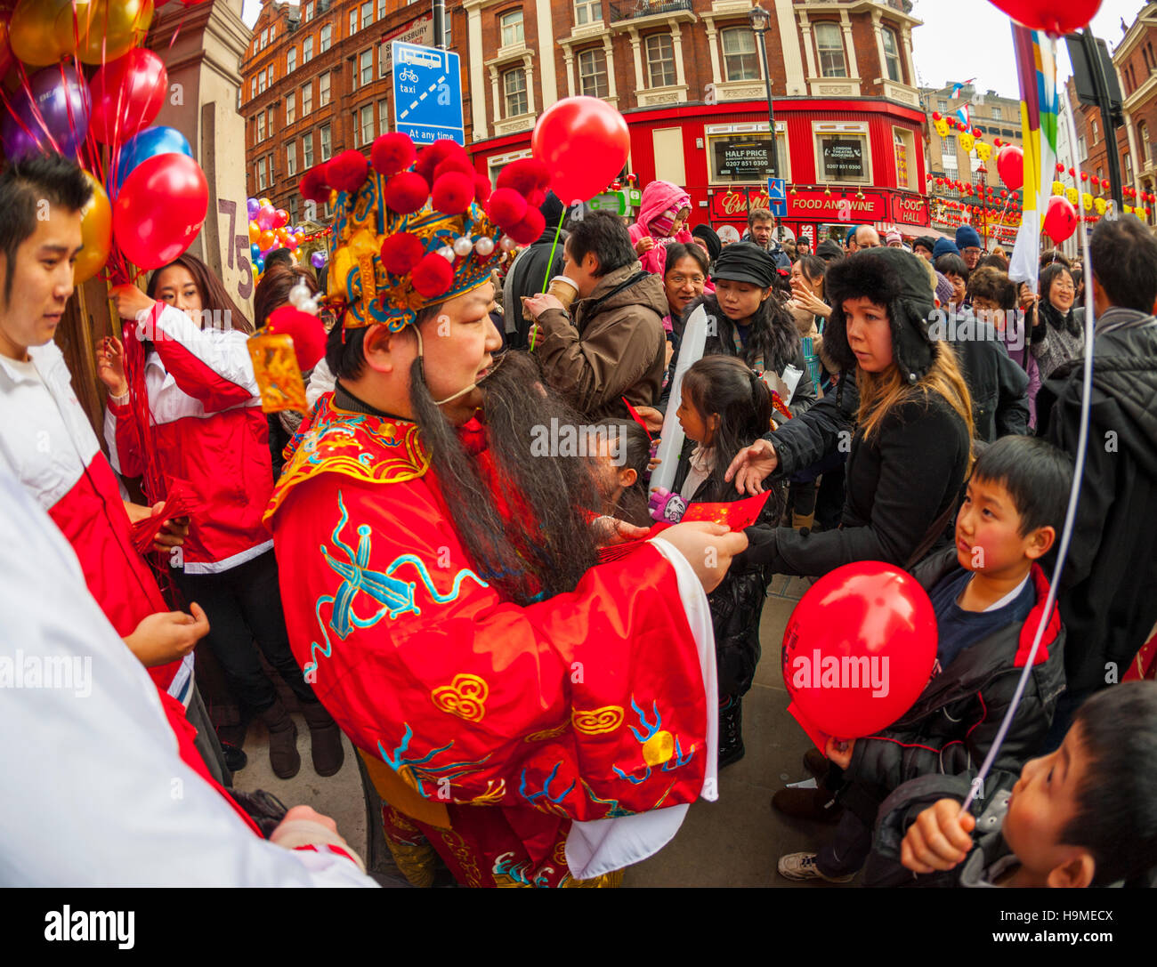 Money being given out as good luck at Chinese New year celebrations in London Stock Photo
