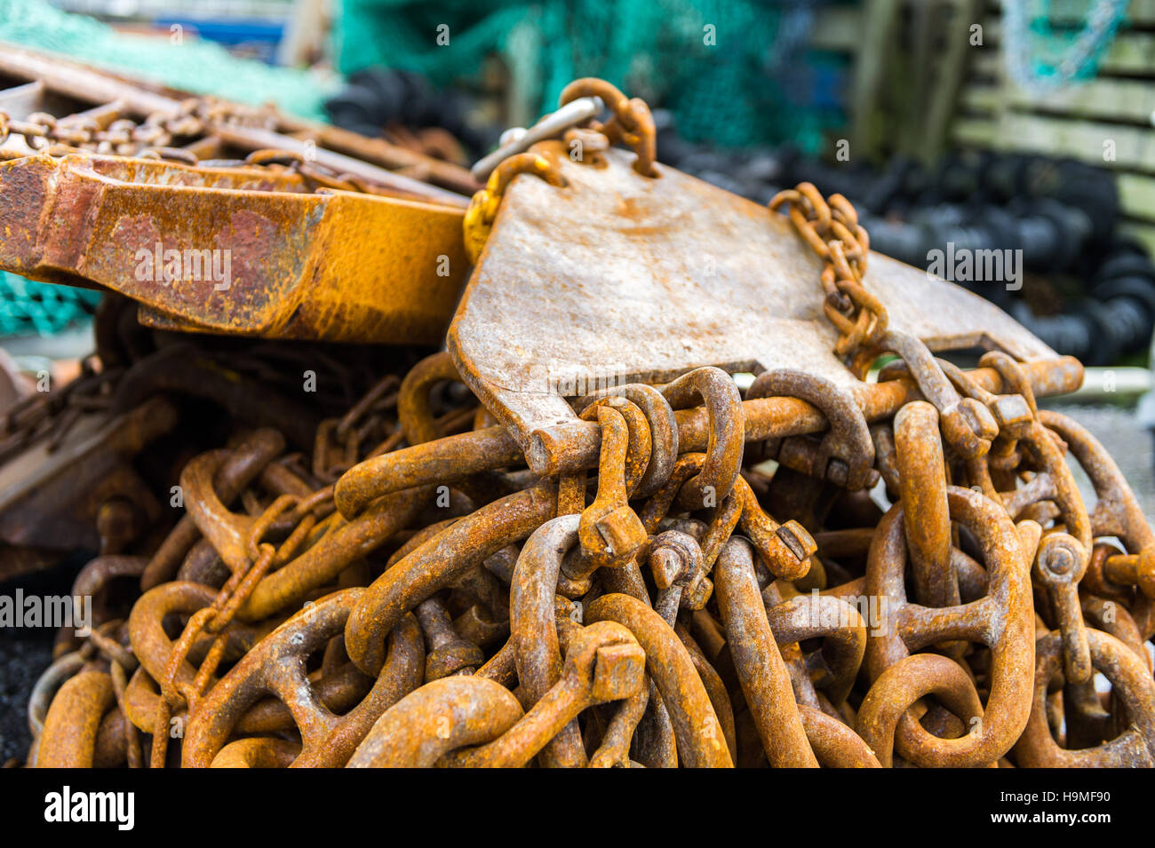 Rusty commercial fishing equipment pictured on the dock side/quay. Stock Photo
