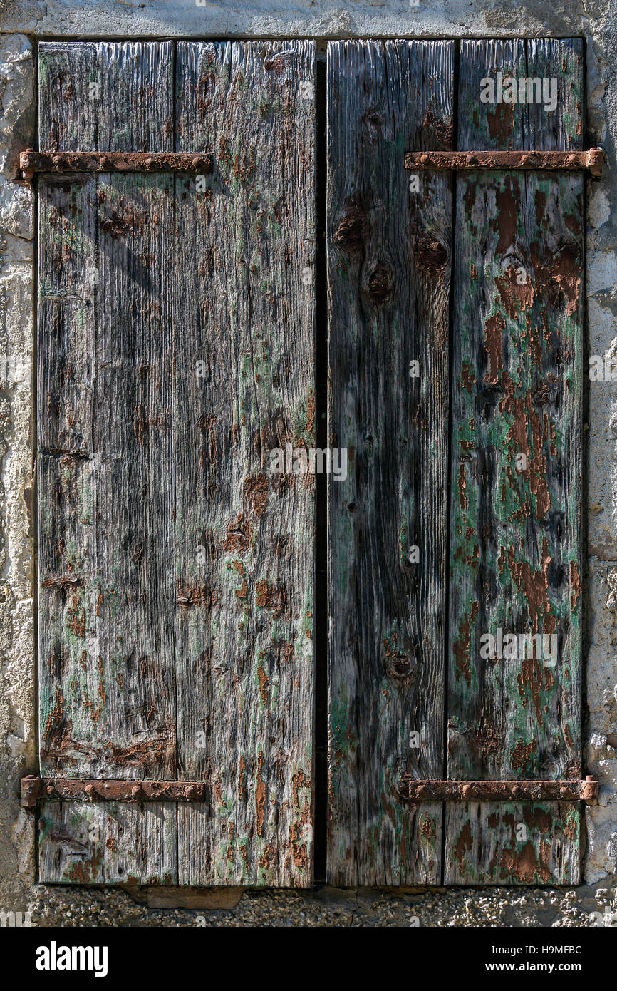 Peeling paint on old wooden window shutters on an old barn in Sarlat in ...