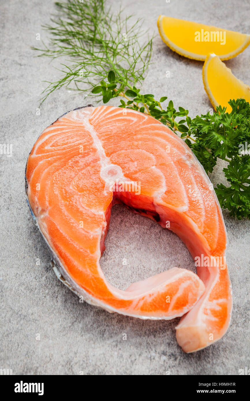 Fresh salmon fillet slice on dark stone background with fennel a Stock ...