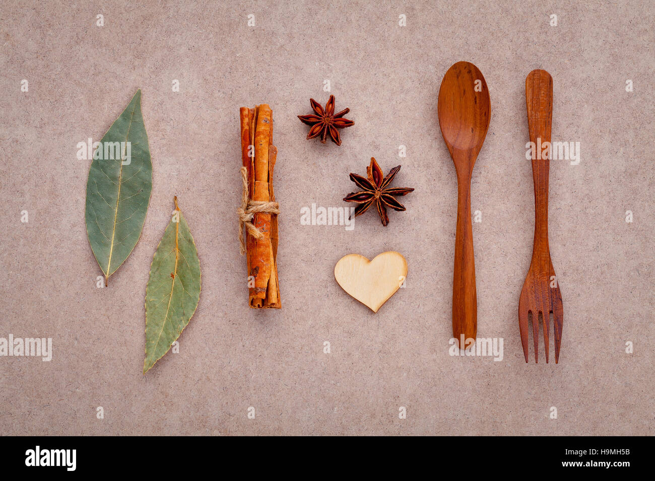 Wooden spoon and fork with cinnamon sticks ,star anise ,wooden h Stock Photo