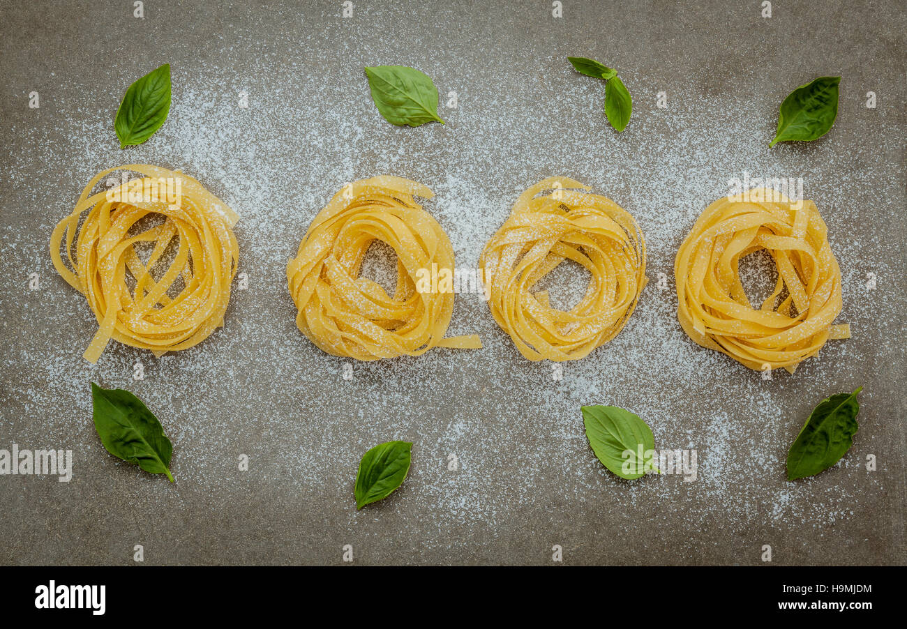 Italian food concept pasta with sweet basil with flour setup on Stock Photo