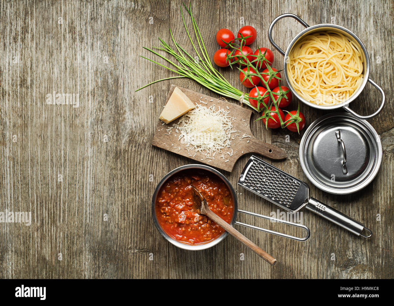 Pasta with bolognese sauce and parmesan cheese on wooden table Stock Photo